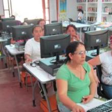 Women farmers at a computer class in the library.