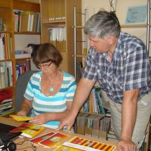 A librarian shows a farmer how to produce brochures.