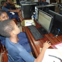 A young boy researches the internet in the Tanzania Central Library's computer room.