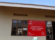 Front of Mbarara Public Library building, showing sign advertising Airtel internet access at the library.