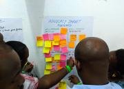 A group of Kenya National Library Service trainers post sticky notes to newsprint during training in Mombasa, Kenya.