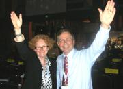 Happy photo of EIFL's Teresa Hackett and Bookshare's Jim Fruchtermann mark adoption of the treaty in Marrakesh, each with an arm raised in celebration. 