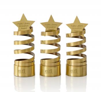 Three innovation award trophies - a spiral design, with a star on top.