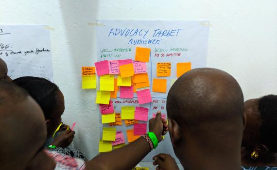 A group of Kenya National Library Service trainers post sticky notes to newsprint during training in Mombasa, Kenya.