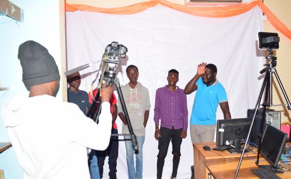 A group of young photographers try out the cameras and other equipment in the library.