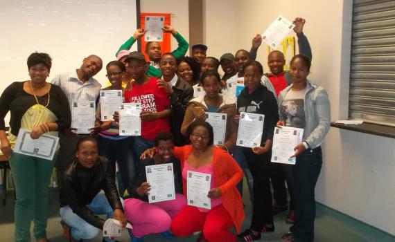 The library’s 2012 intermediate computer and job readiness trainees celebrate their graduation.