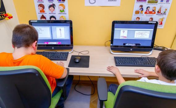 Two children learning digital and financial skills on computers In Prelog City Public Library.